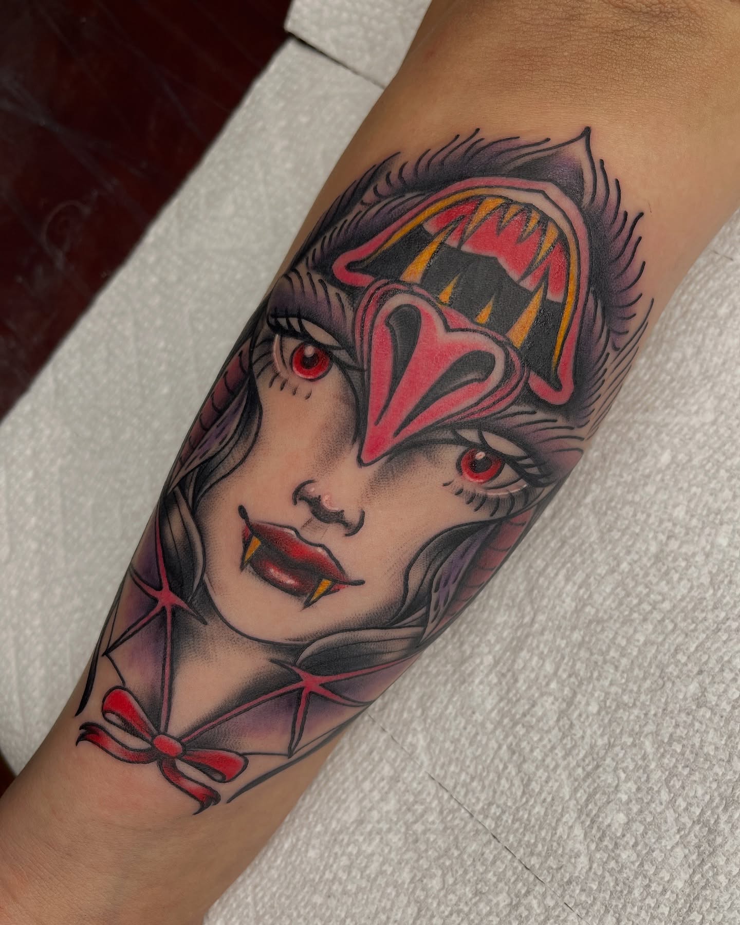 Woman with mask American traditional tattoo on the forearm by Blake Alan Tattoos (TROUT)