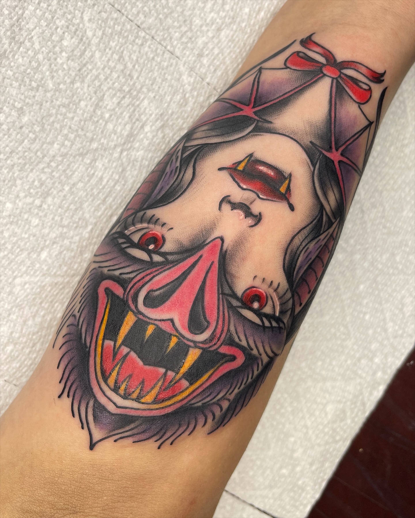 Clown face American traditional tattoo on the forearm by Blake Alan Tattoos (TROUT)