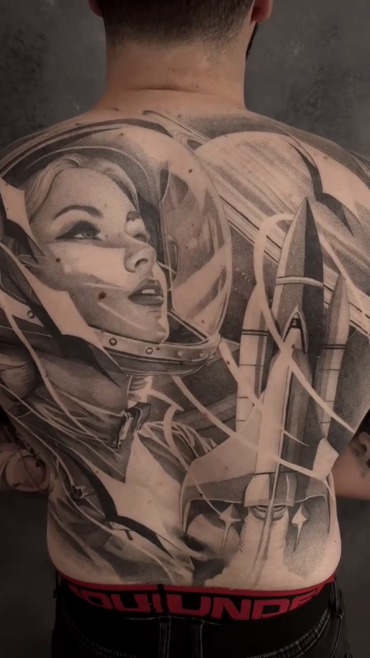 Astronaut woman with space background realism tattoo on the back by Ana Fajardo