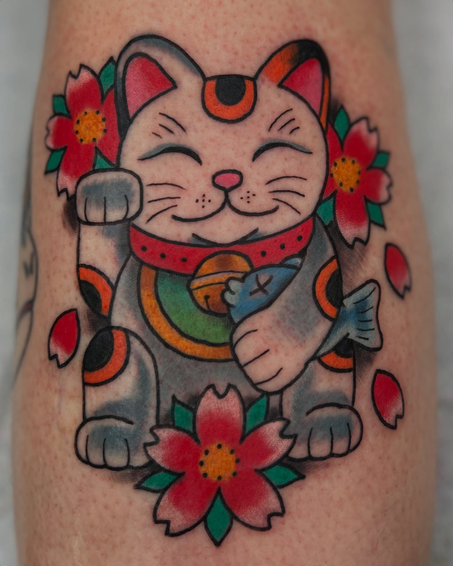 Lucky cat American traditional tattoo on the forearm by Alex Fannin
