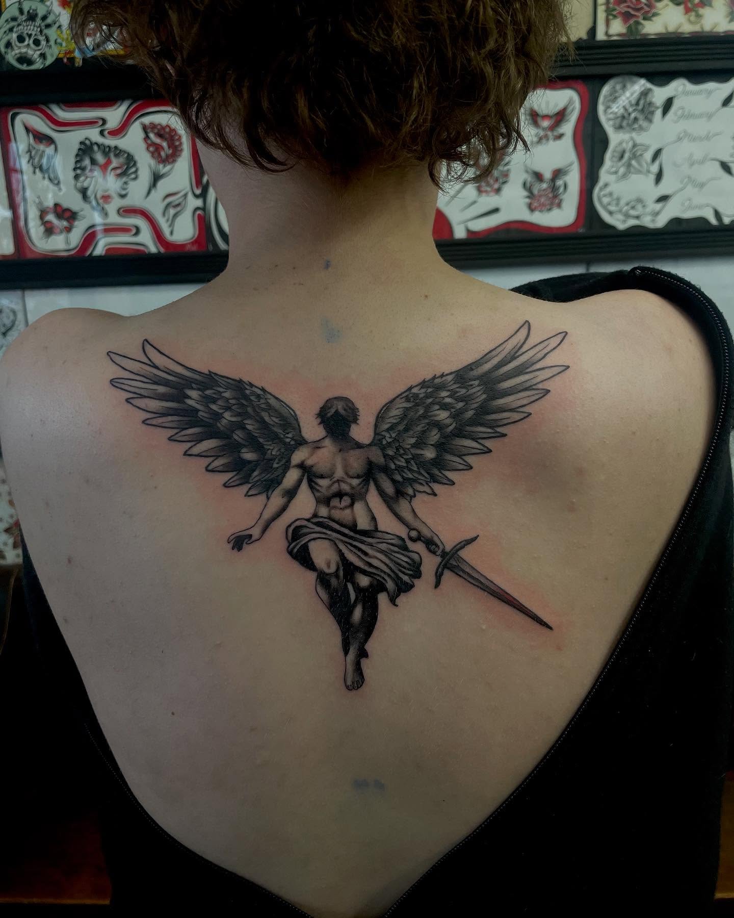 Angel with sword black and grey tattoo on the back by Kylee langford 🧿