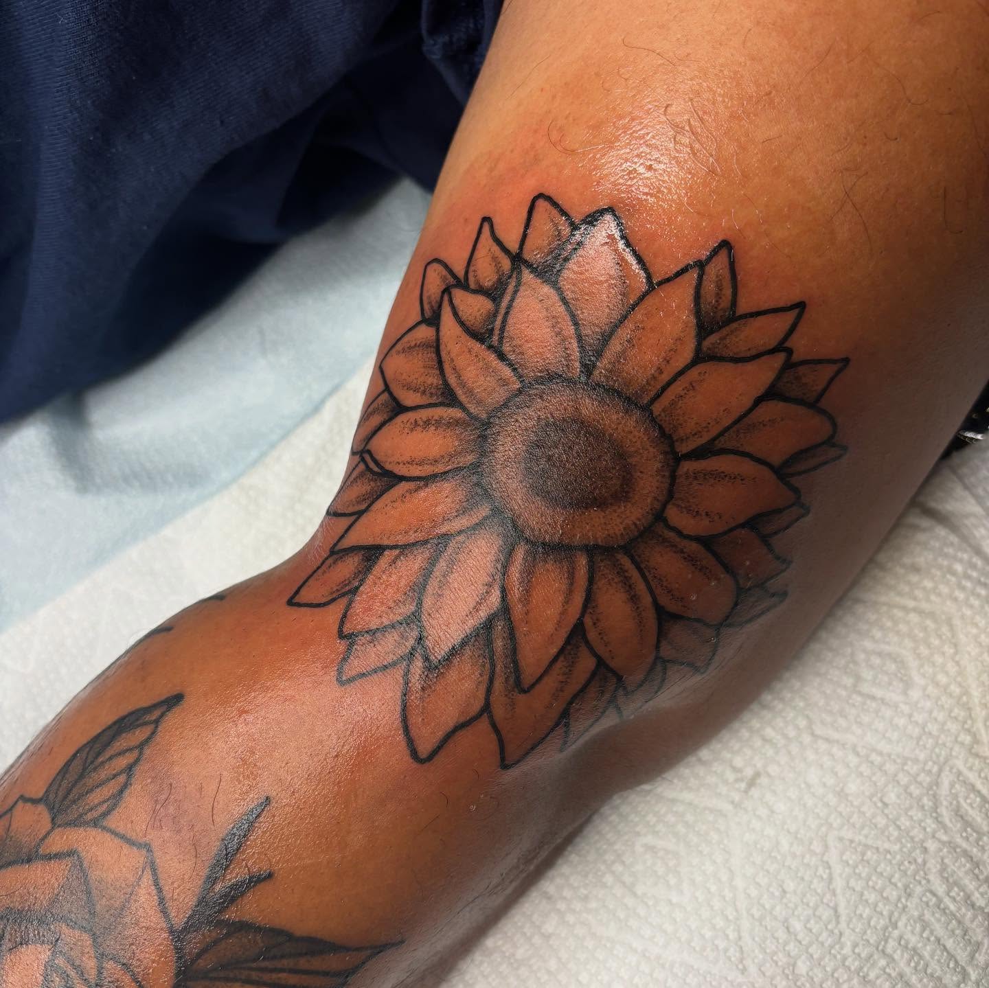 Sunflower black and grey tattoo on the forearm by Emmy Gallagher