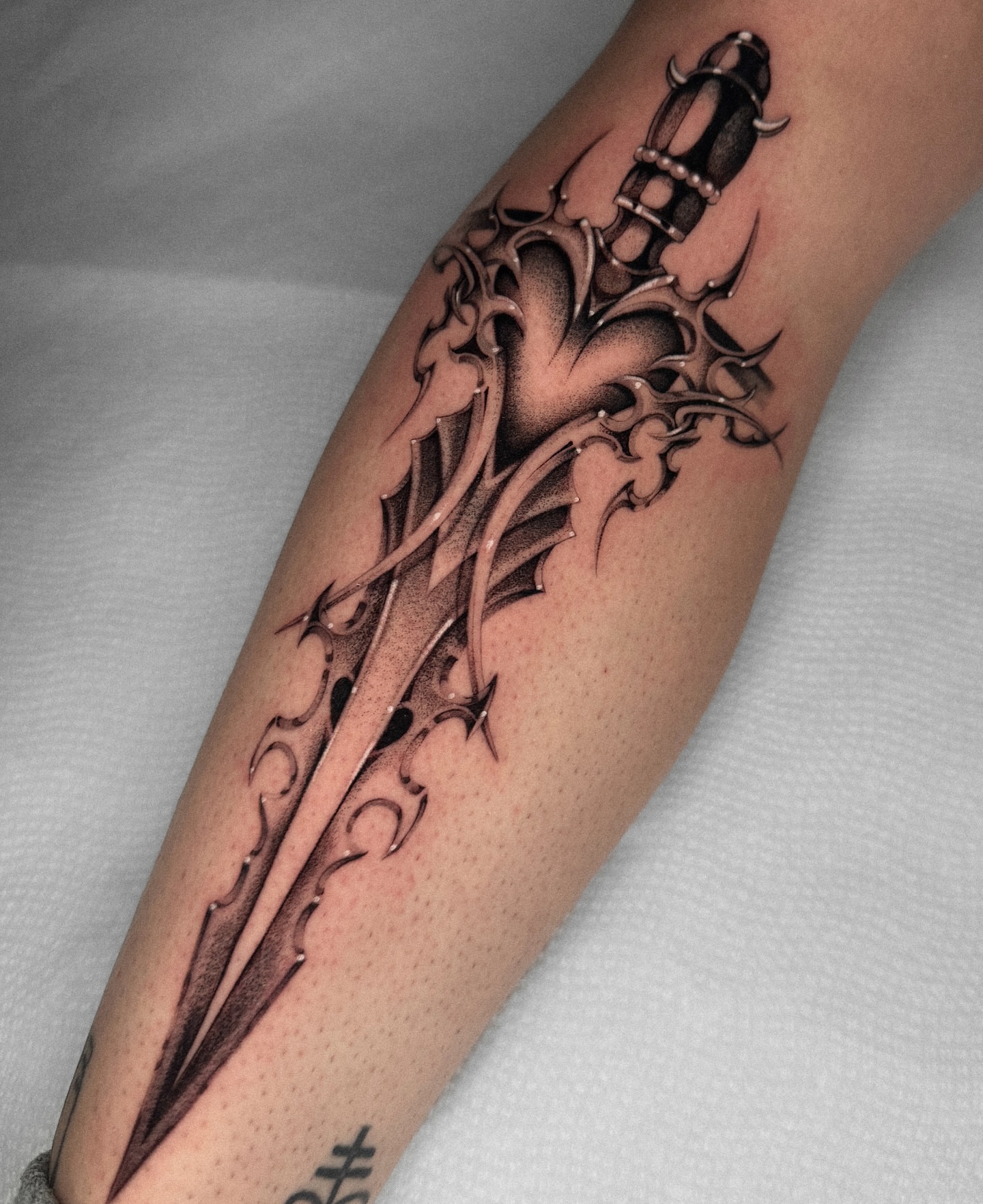 Sword and flame tribal tattoo on the forearm by ella