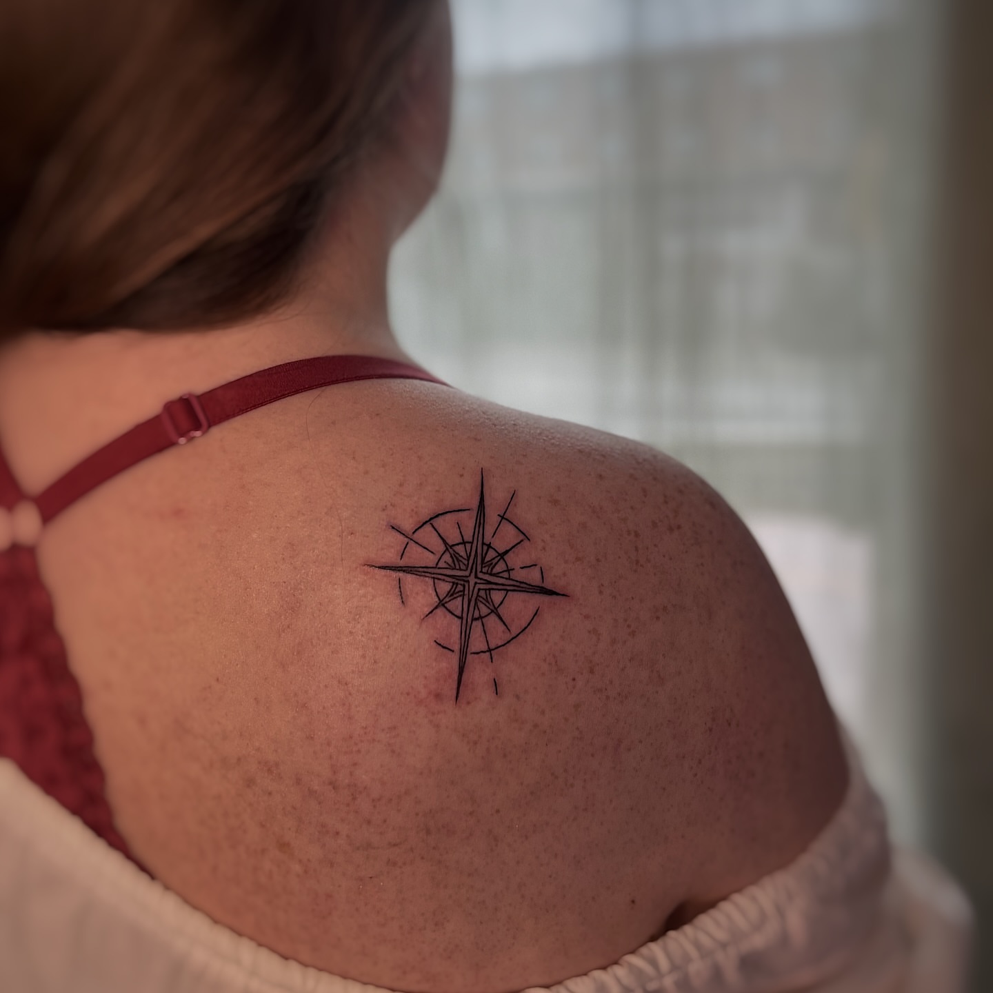 Compass geometric tattoo on the shoulder by Nikki Ward