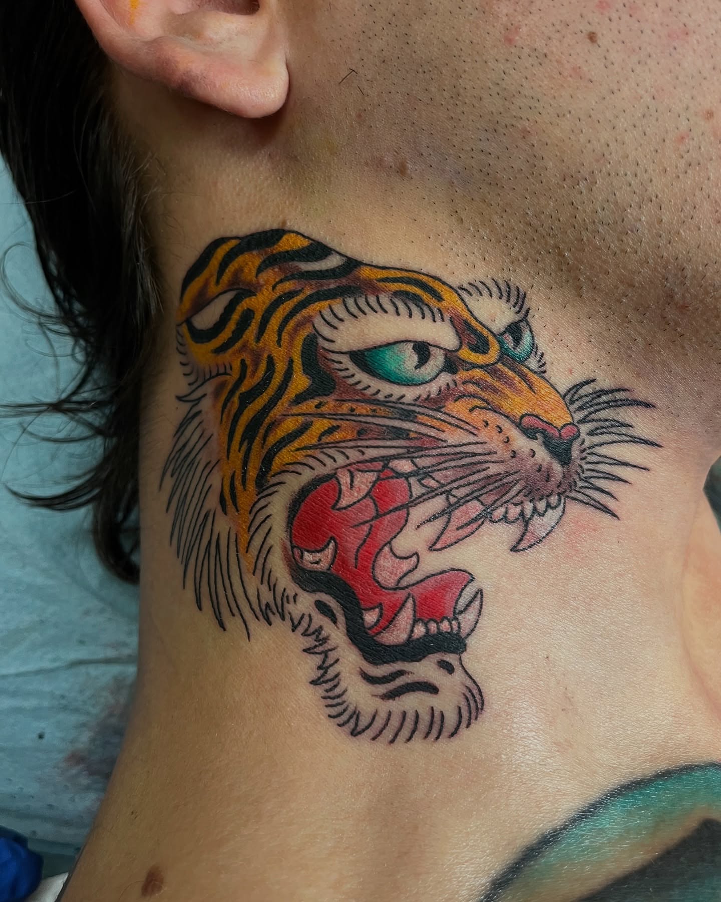 Tiger American traditional tattoo on the neck by Graham Niles