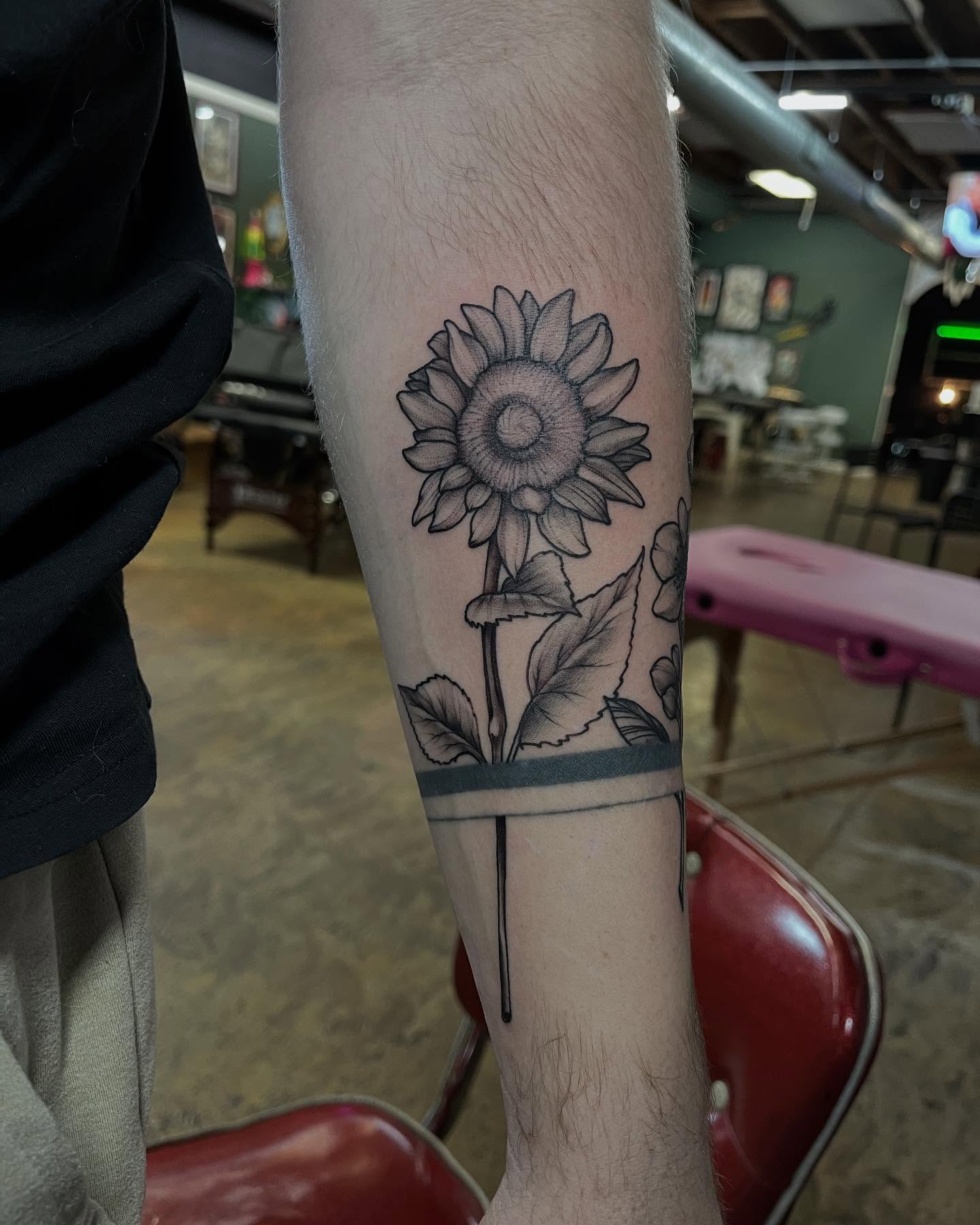 Sunflower black and grey tattoo on the forearm by Dallas Davis