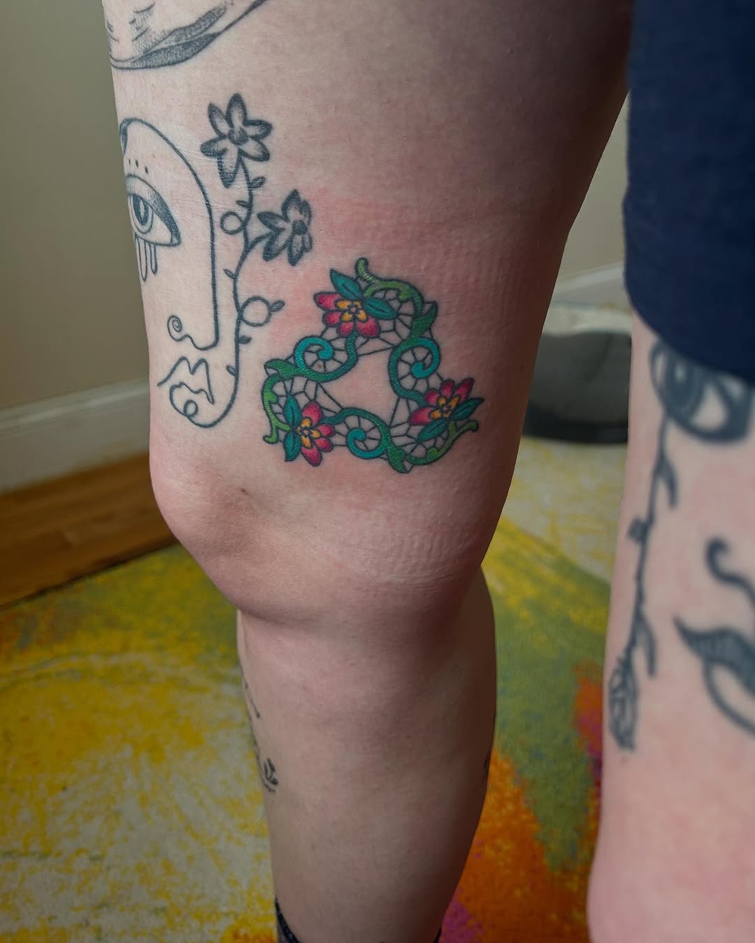 Geometric floral design American traditional tattoo on the leg by Emma D