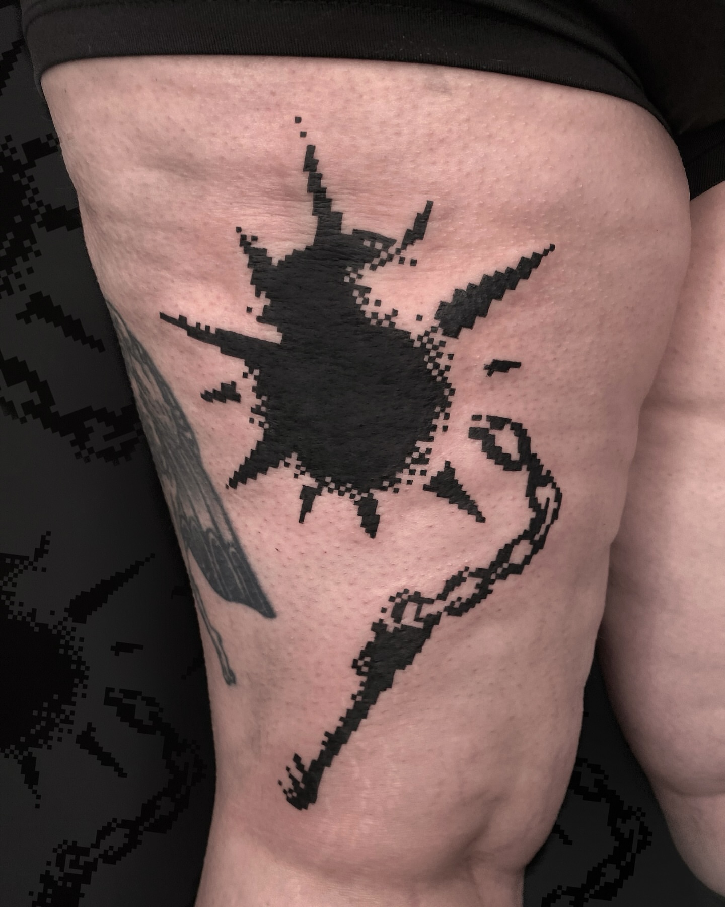 Pixelated splash dotwork tattoo on the thigh by Sarah