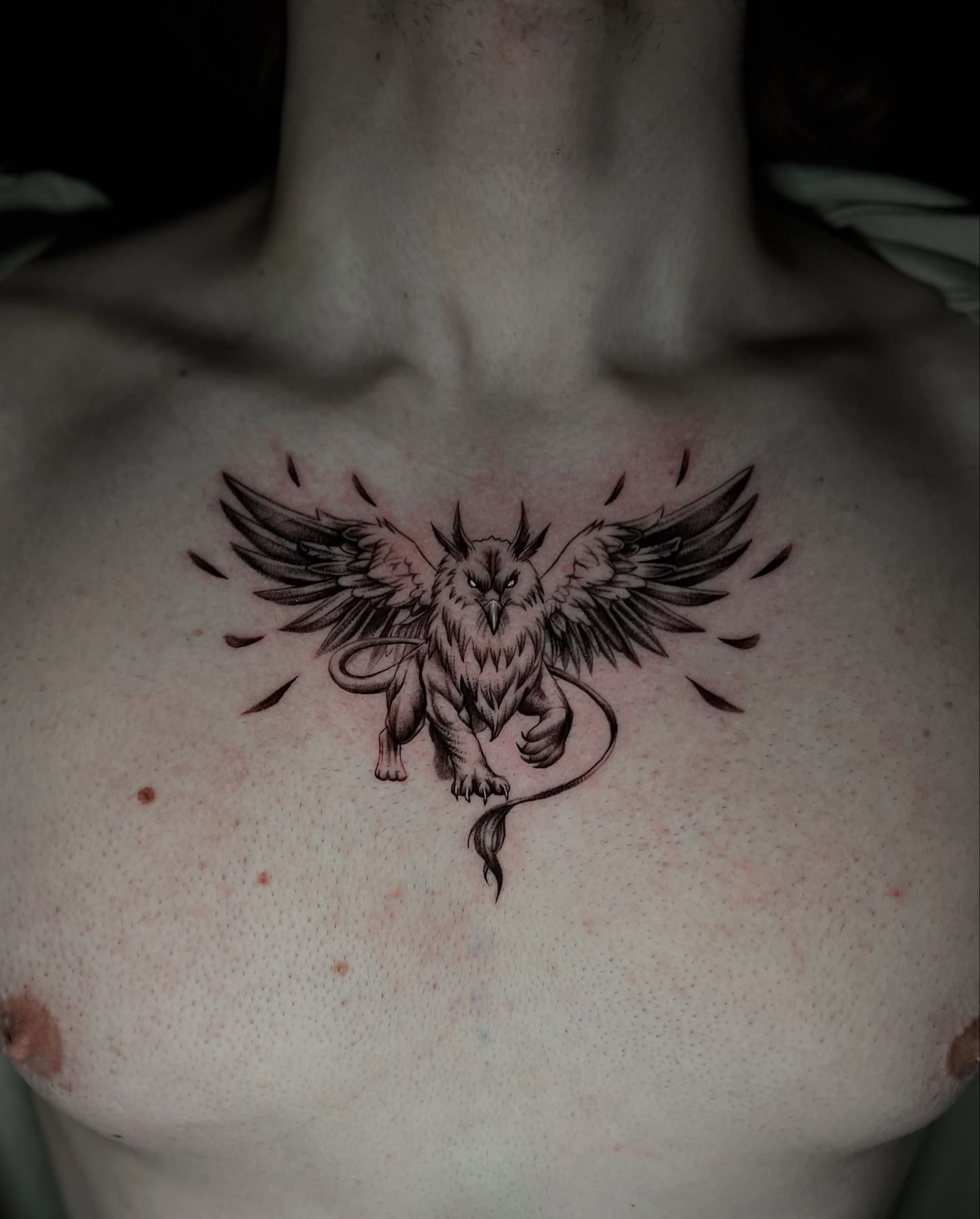 Winged creature black and grey tattoo on the chest by Tommy Nguyen, Eastpointe, Michigan