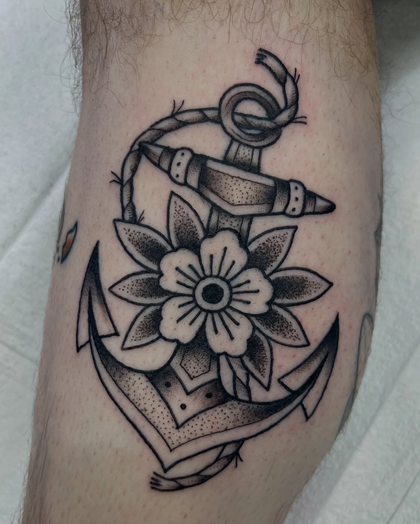 Anchor with flower American traditional tattoo on the forearm by jenna clark🎨