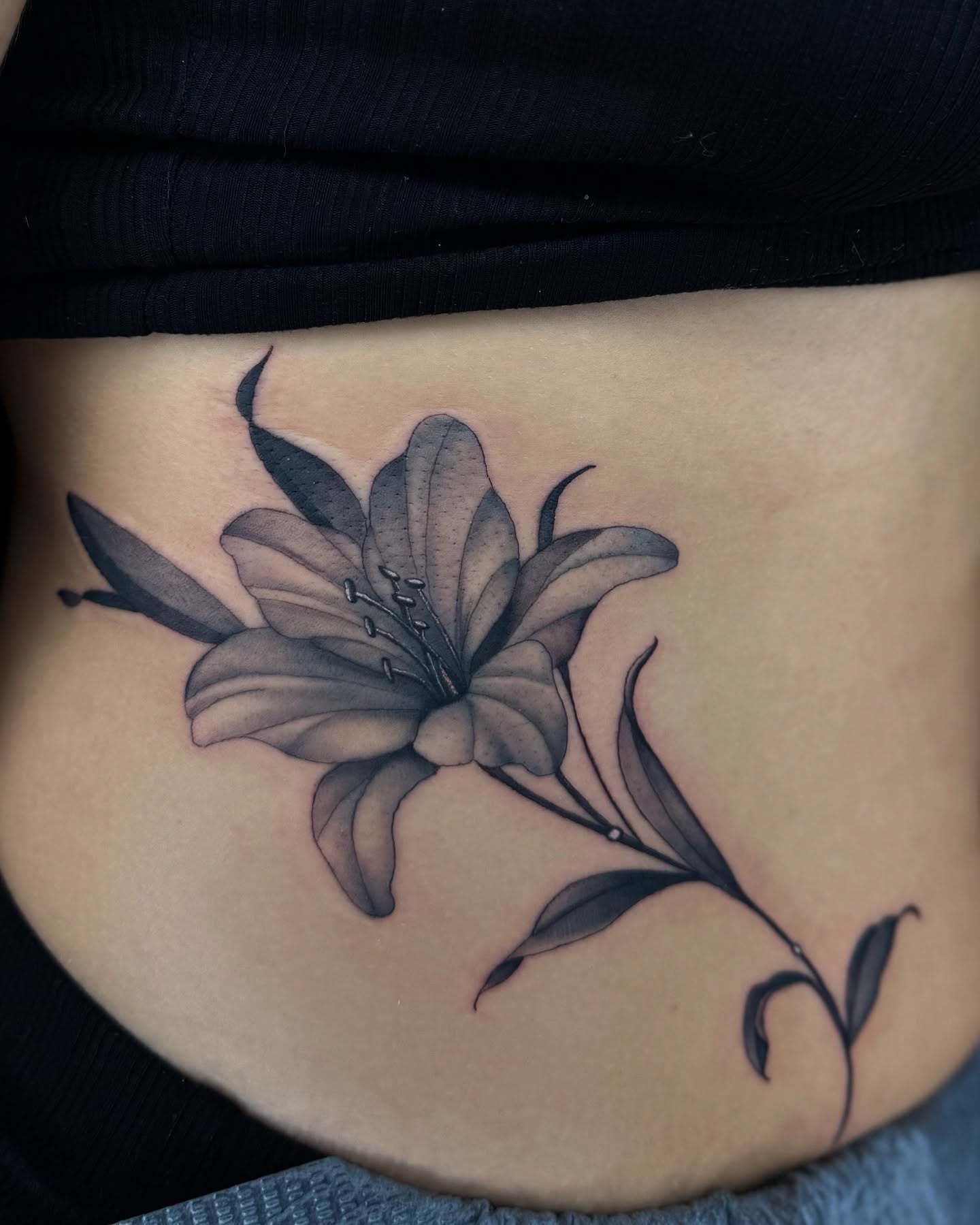 Lily black and grey tattoo on the torso by Chris_Tatt2_D’Ascenzo