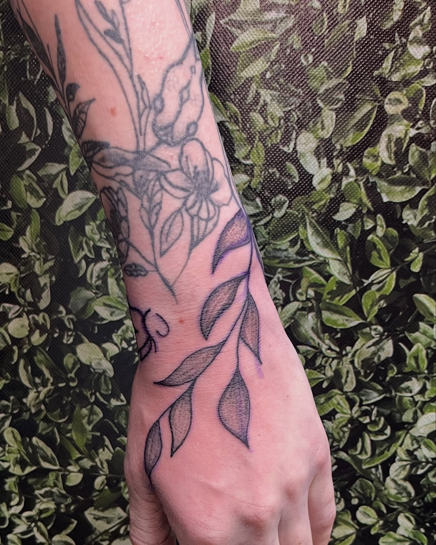 Floral design black and grey tattoo on the forearm by Michelle