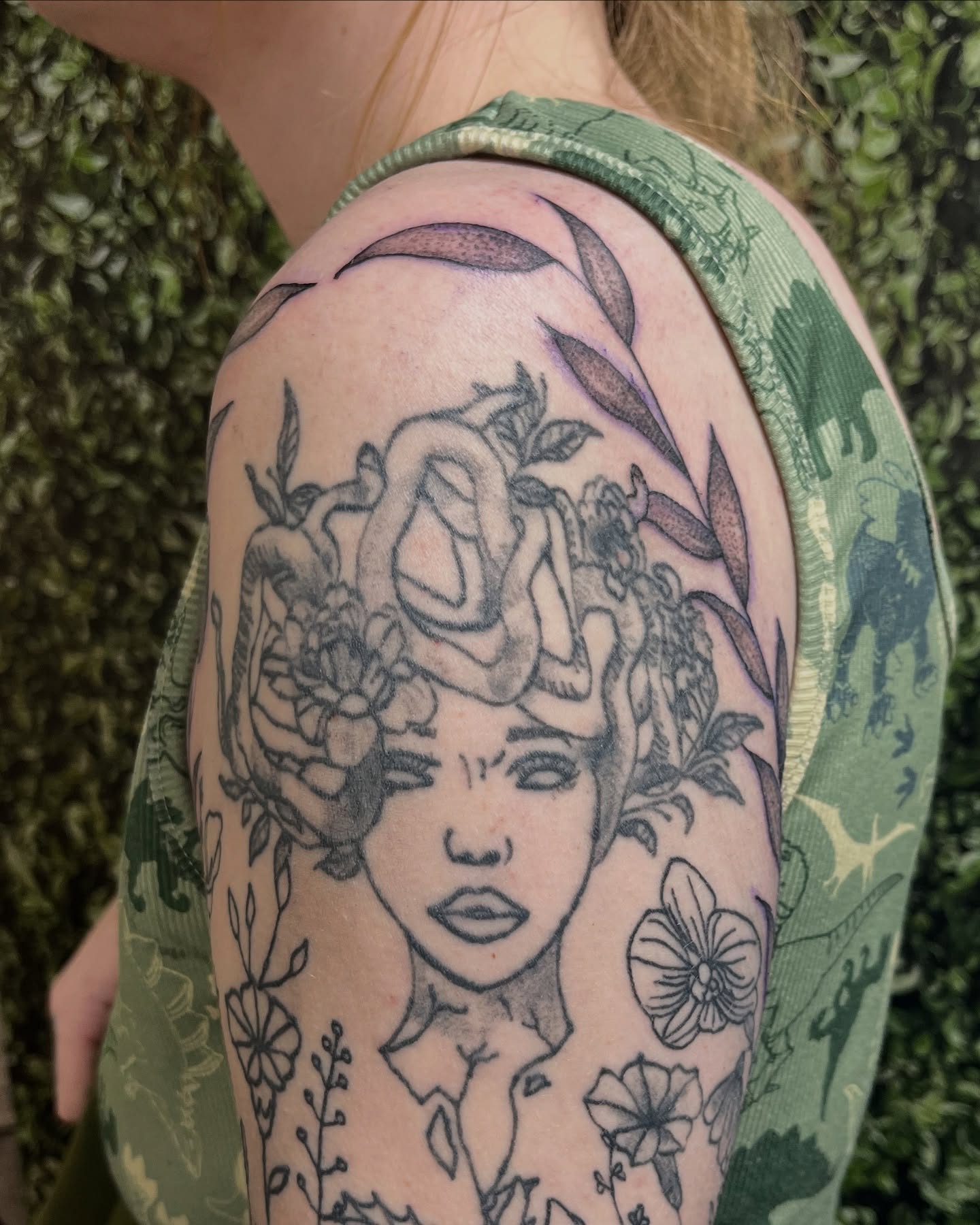 Woman with floral crown realism tattoo on the shoulder by Michelle