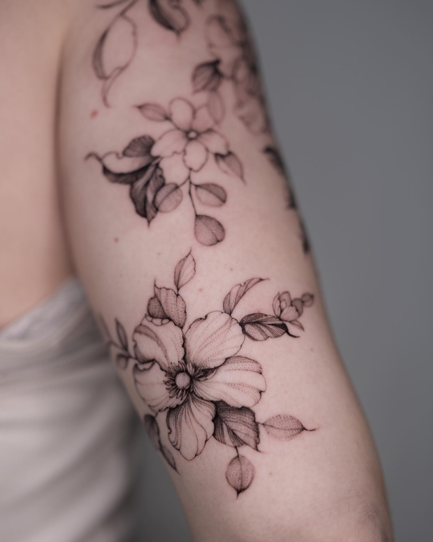Flowers black and grey tattoo on the forearm by Tattoo artist in Boston