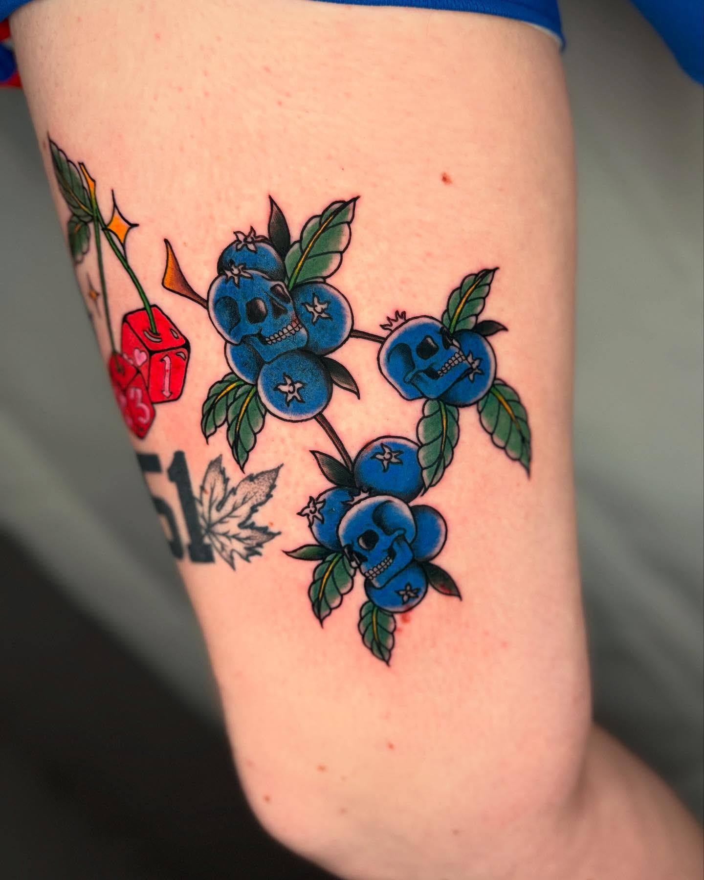 Blueberries with skulls American traditional tattoo on the forearm by Amber Starr, Midvale, Utah