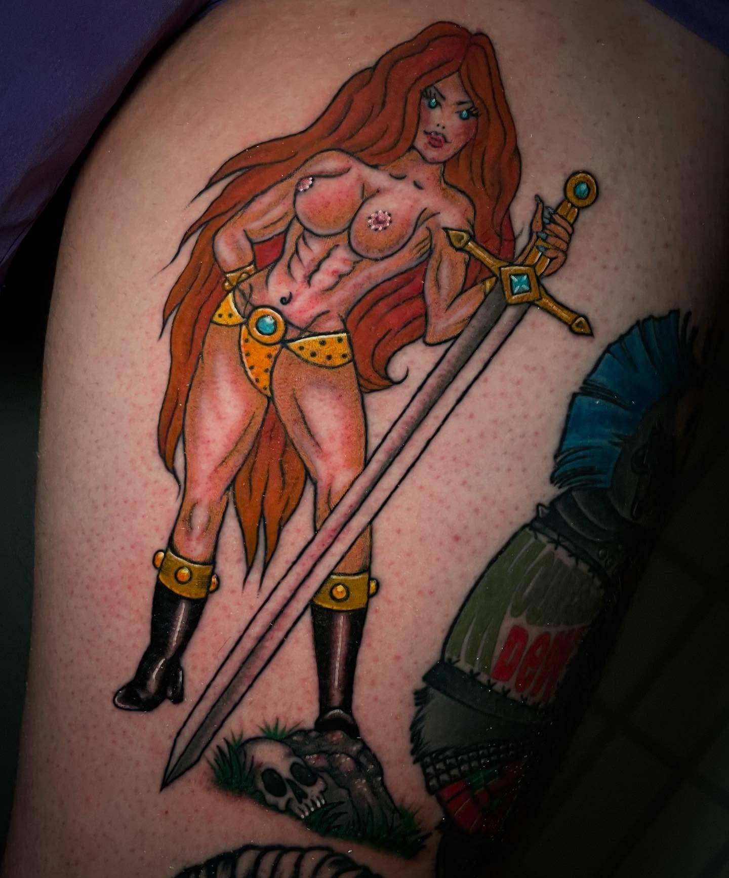 Female warrior illustrative tattoo on the thigh by Madison ‘Maddog’ Stewart