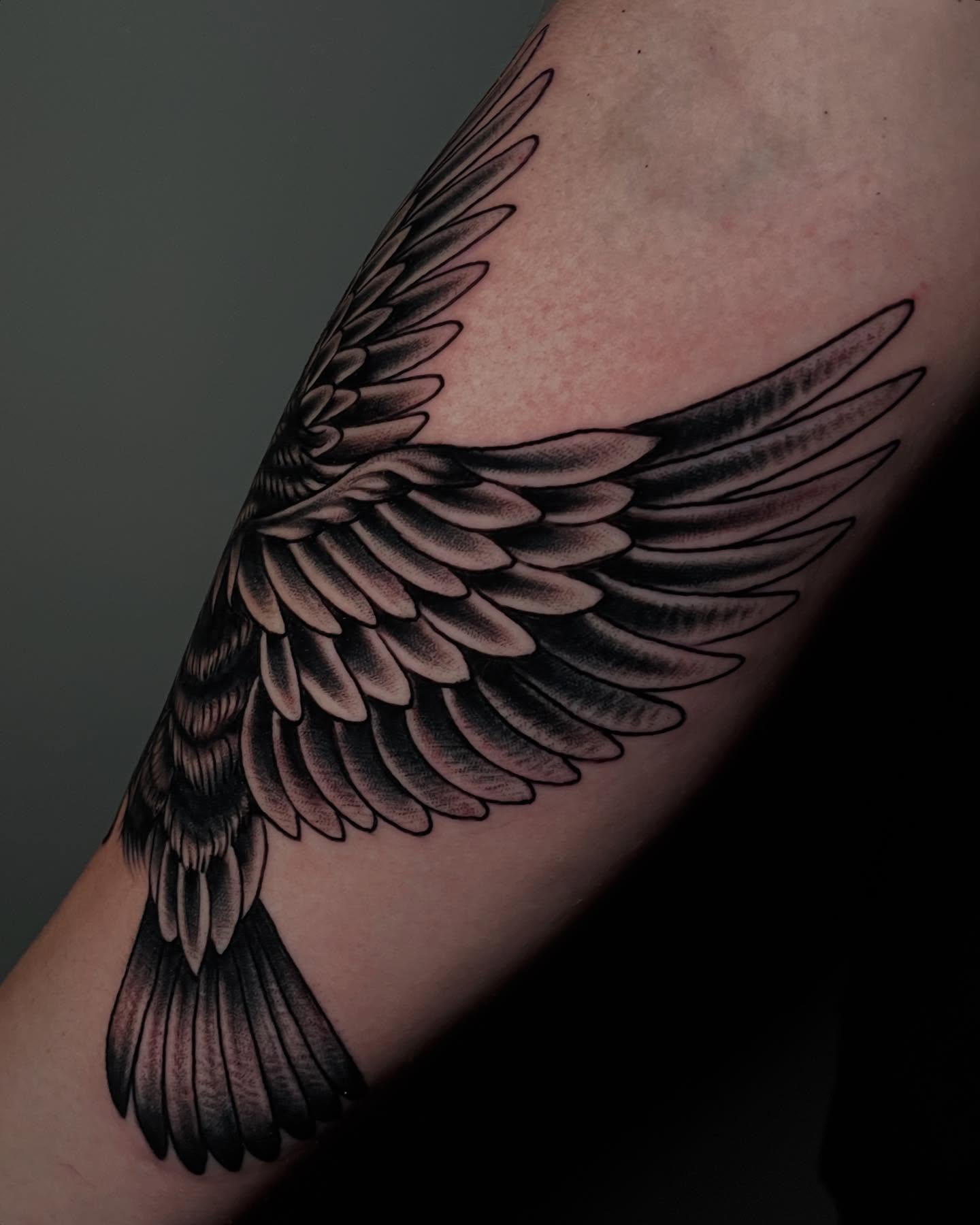 Wings black and grey tattoo on the forearm by Madison ‘Maddog’ Stewart