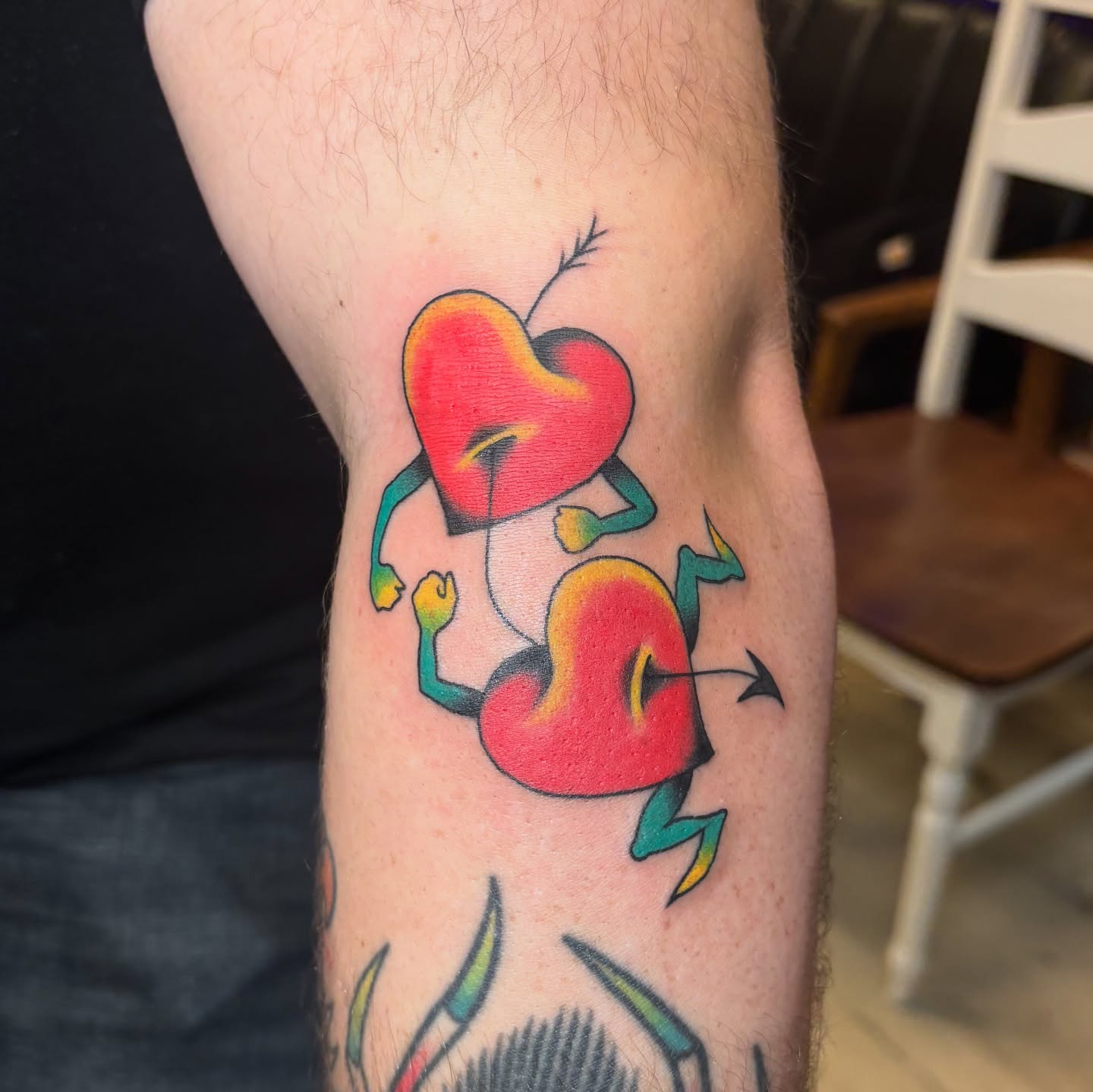 Two hearts dancing American traditional tattoo on the forearm by Jordan Wray
