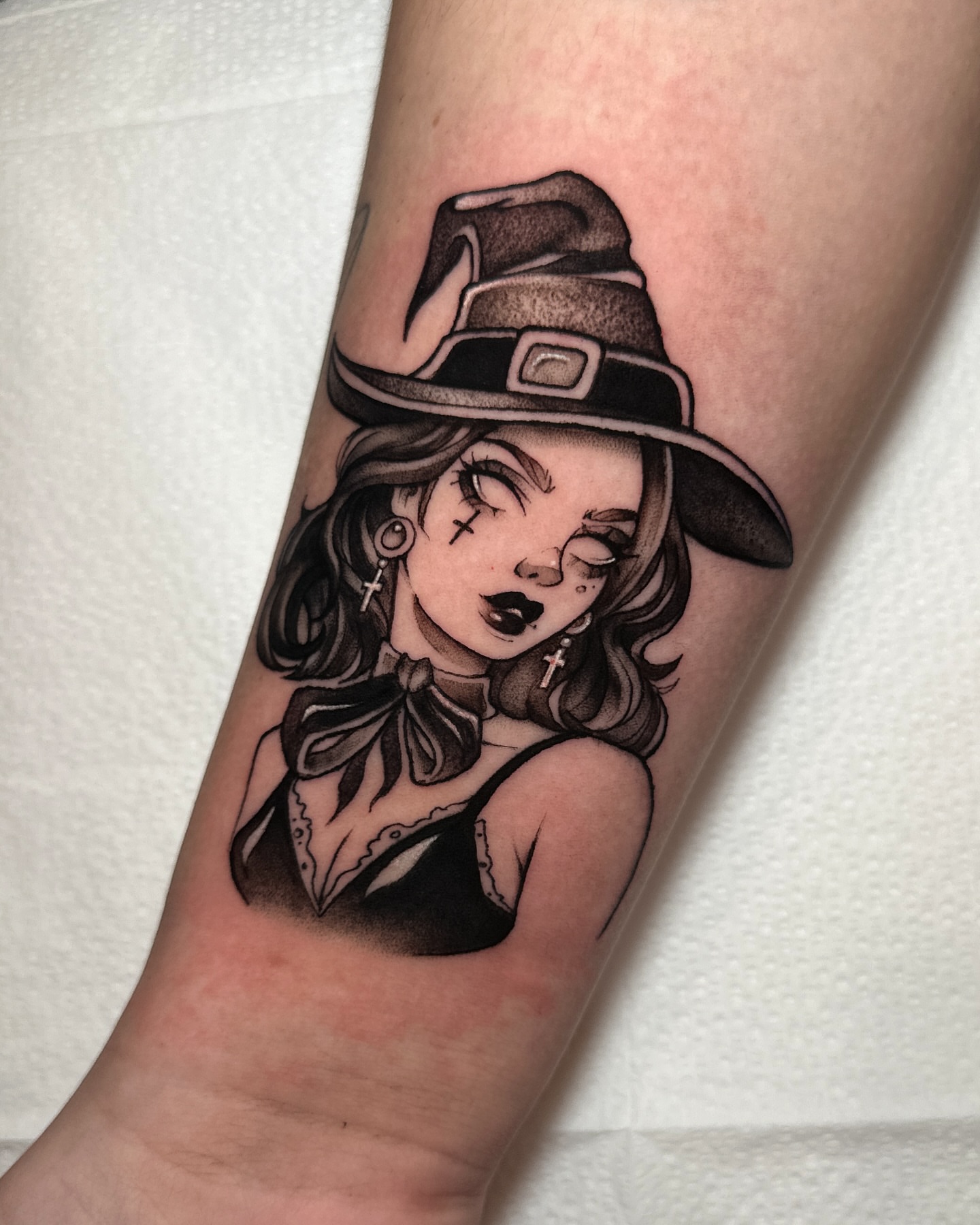 Witch black and grey tattoo on the forearm by Macayla Myers