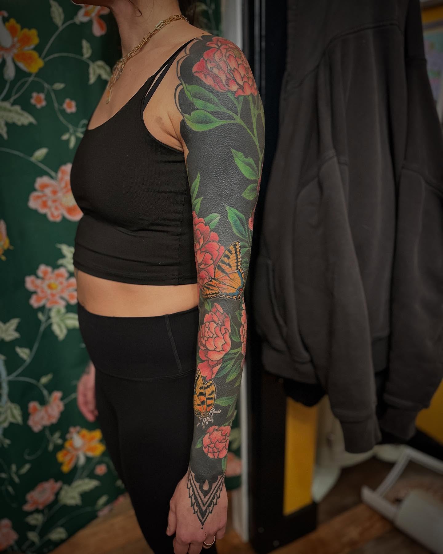 Peony and butterfly new school tattoo on the upper arm by Megon Shore, Seattle, Washington