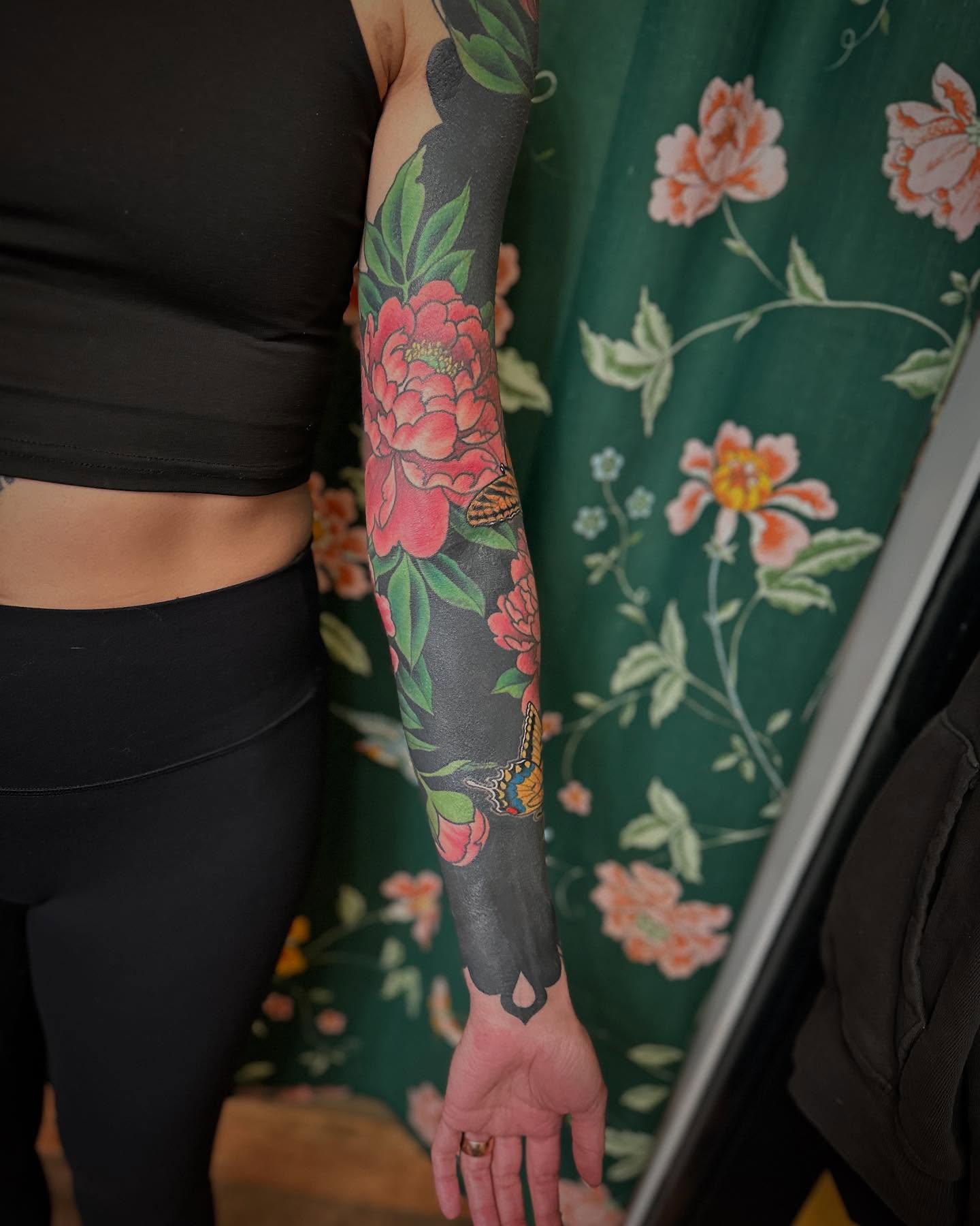 Floral sleeve new school tattoo on the upper arm by Megon Shore, Seattle, Washington