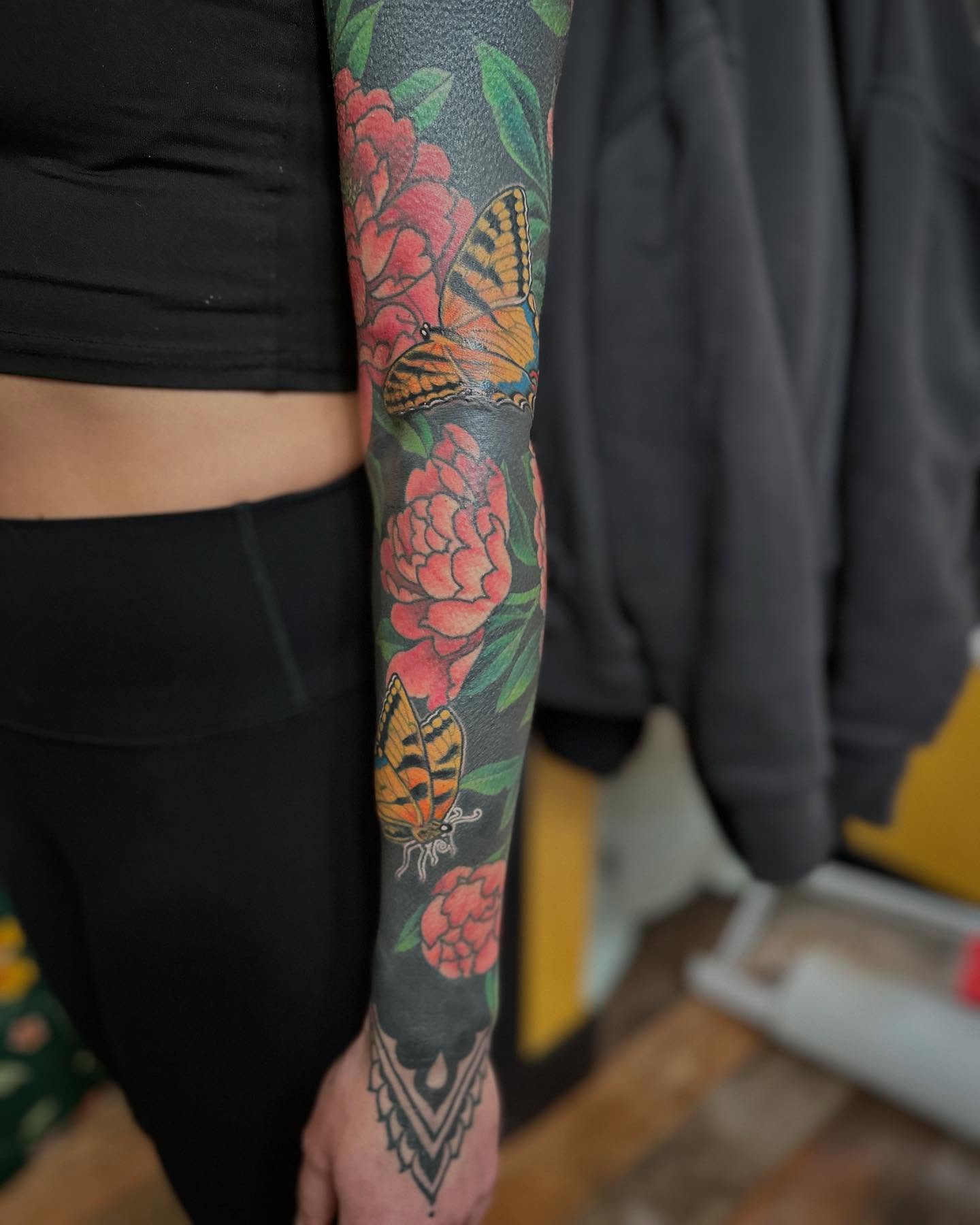 Butterflies and flowers new school tattoo on the forearm by Megon Shore, Seattle, Washington