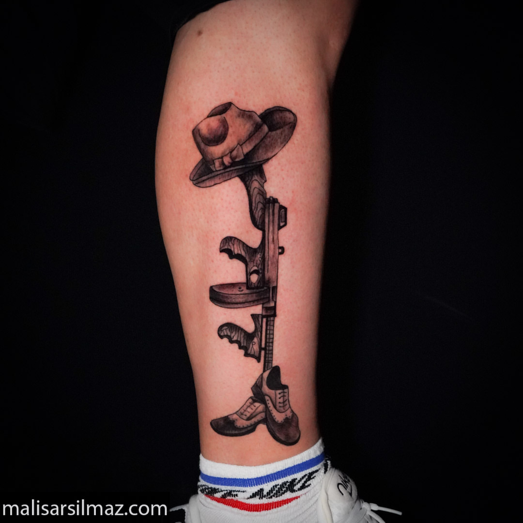 Gun and cowboy hat black and grey tattoo on the forearm by Mali Sarsılmaz, Nicosia, Cyprus