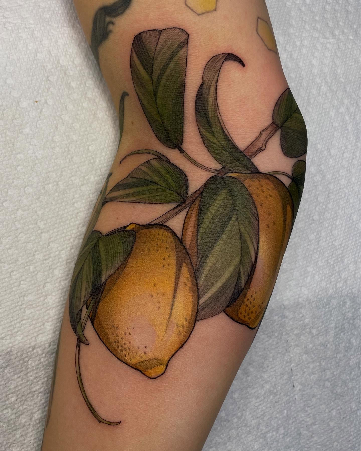 Lemons realism tattoo on the forearm by Carol Jacky