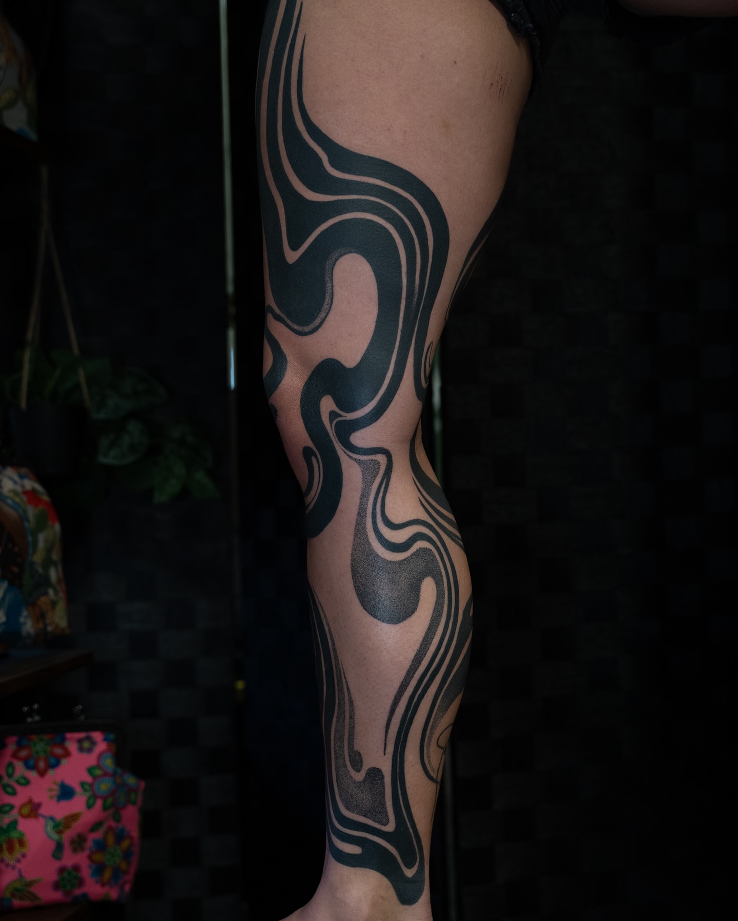 Abstract swirls black and grey tattoo on the calf by Chris Estrada