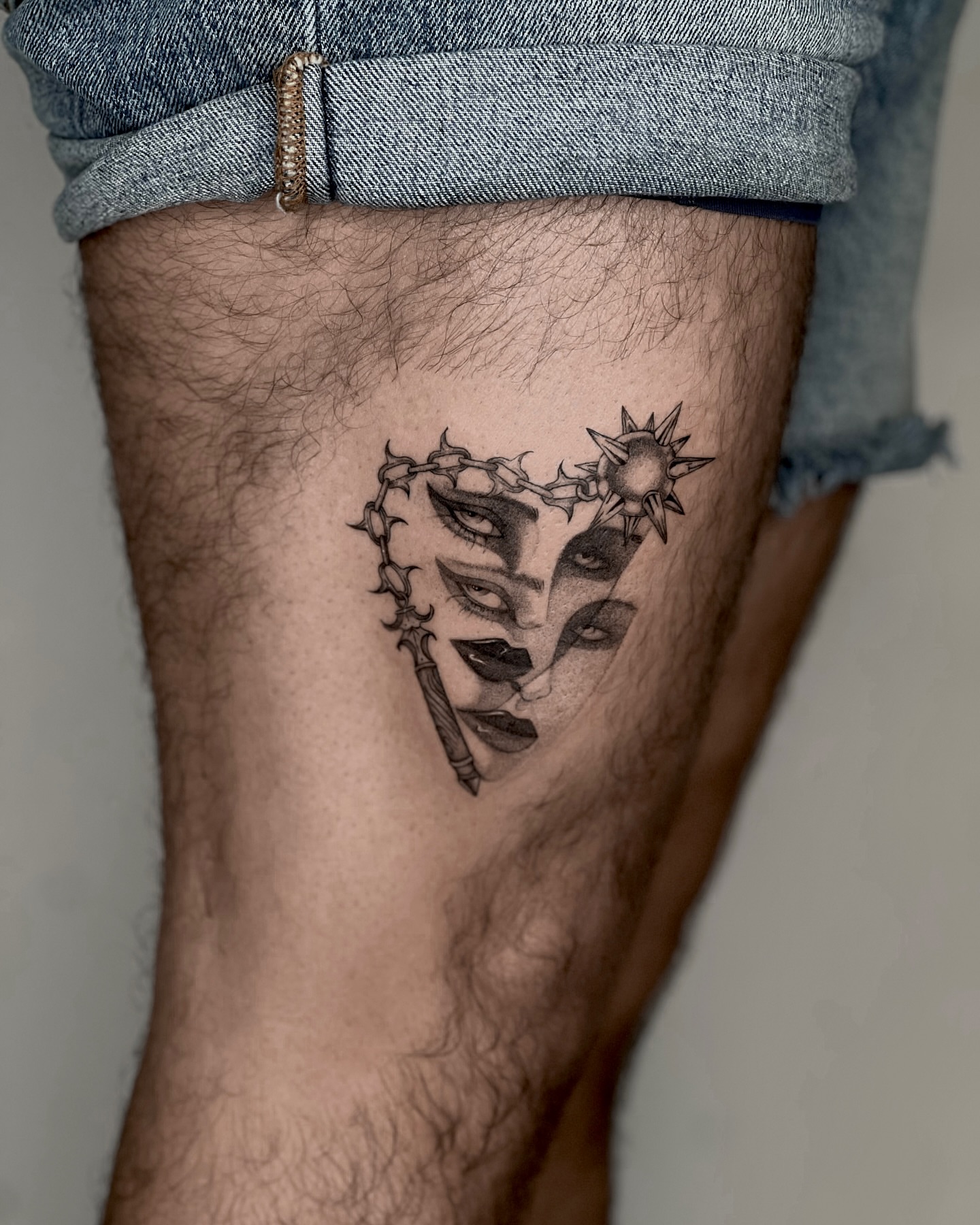 Mask with thorns black and grey tattoo on the thigh by Cybersigilism & Fineline Blackwork