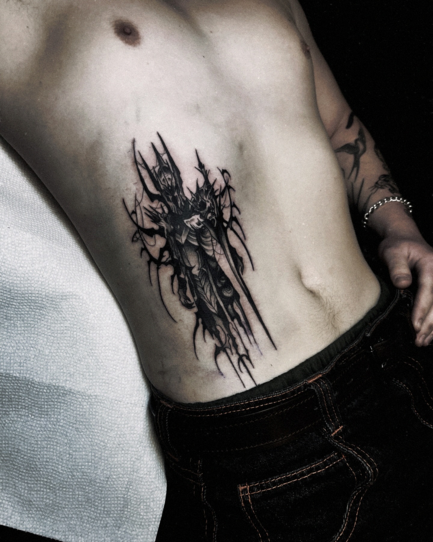 Demon black and grey tattoo on the ribs by Ema Fish