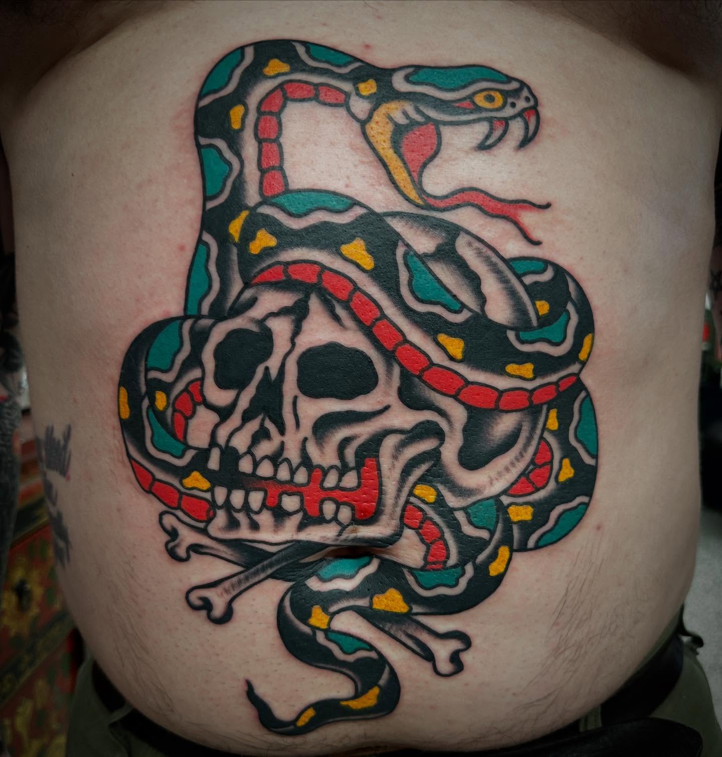 Snake and skull American traditional tattoo on the torso by Nathan Rohrbacher, Nashville, Tennessee