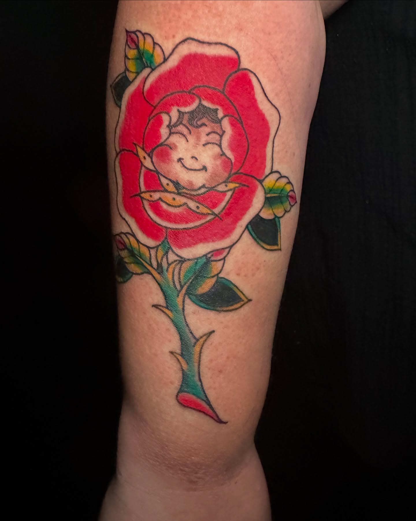 Rose with cherub American traditional tattoo on the forearm by vannadoestattoos