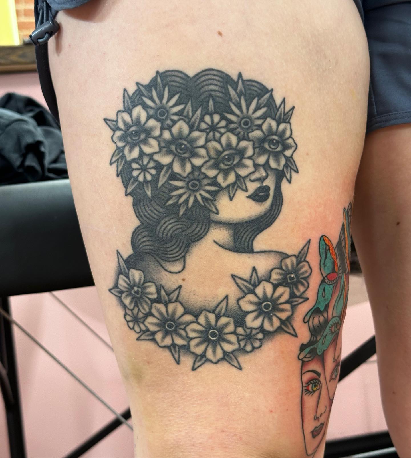 Floral woman black and grey tattoo on the thigh by Marqui Watling