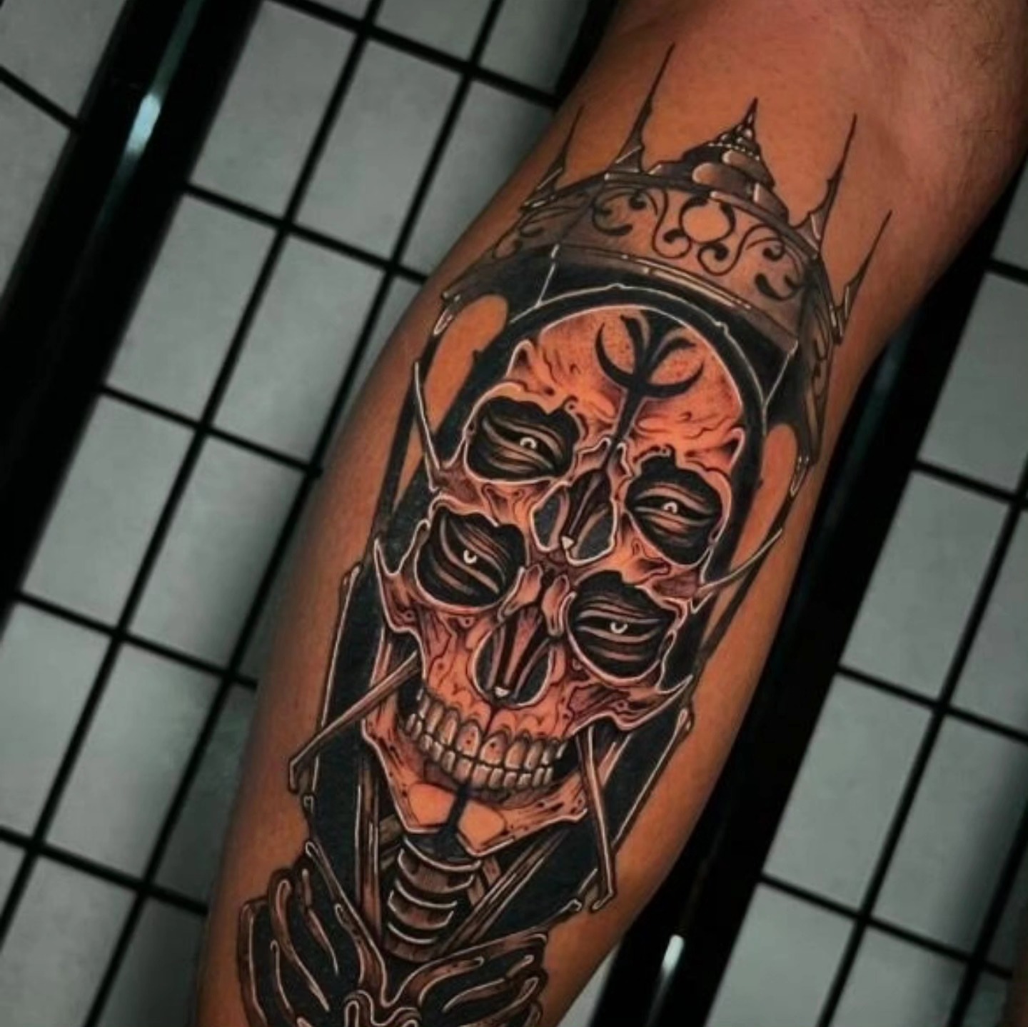 Skull with crown dark realism tattoo on the forearm by Tattoo Artist