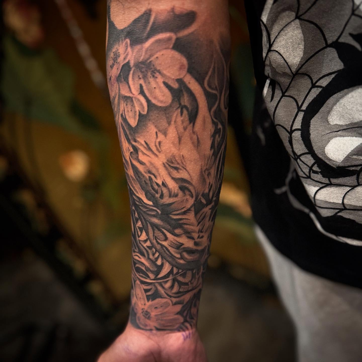 Floral dragon realism tattoo on the forearm by Bernie calderon, Fresno, California