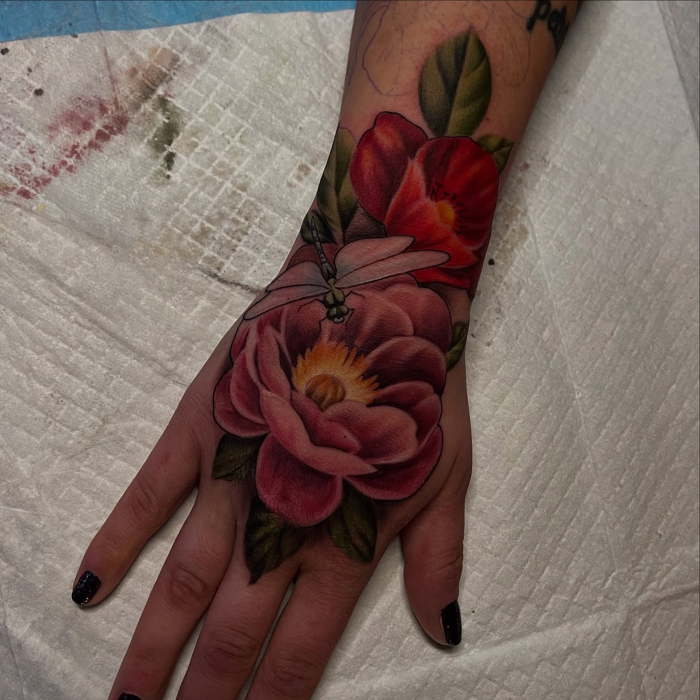 Flower and dragonfly realism tattoo on the hand by Brittany Welsh, Marlton, New Jersey