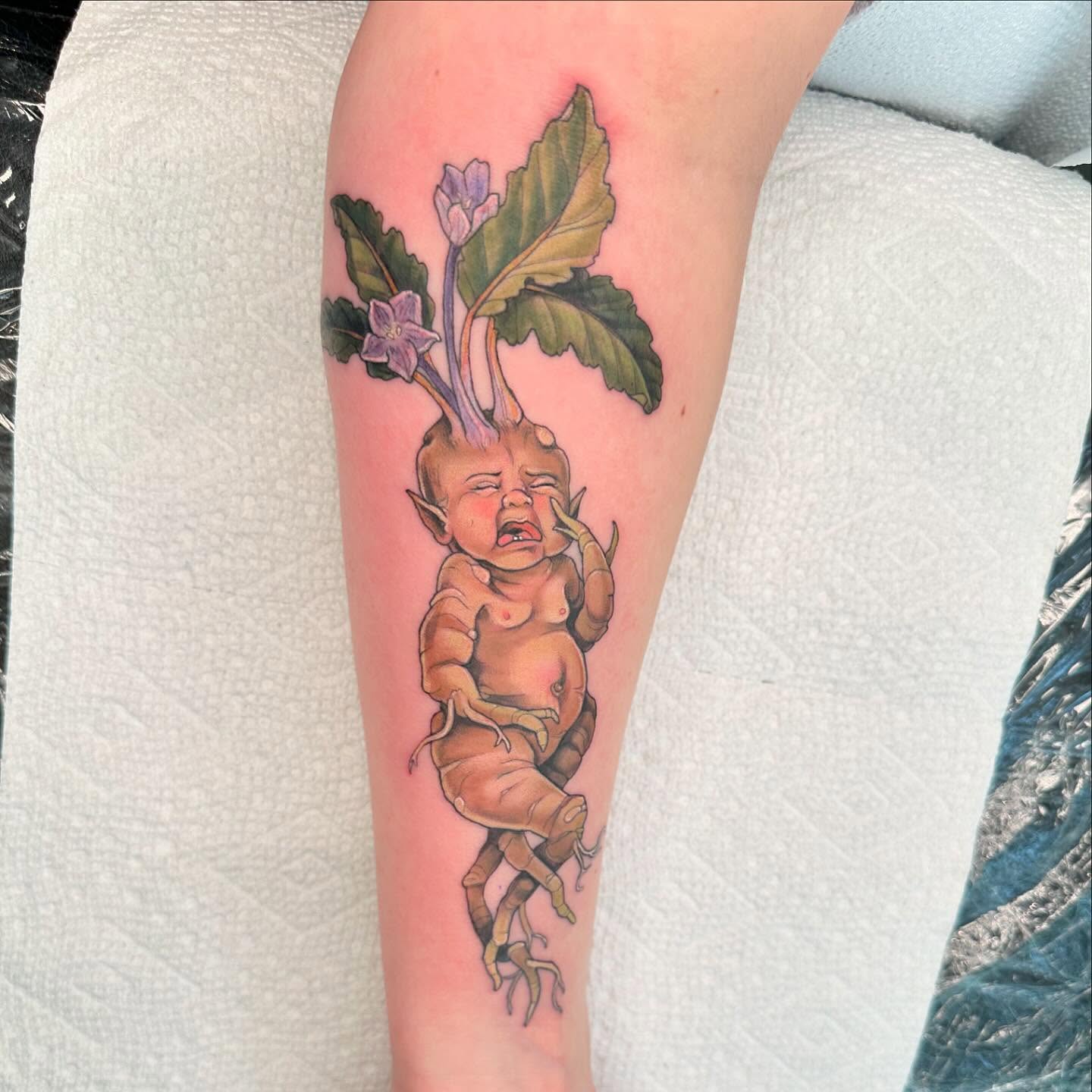 Root vegetable baby realism tattoo on the forearm by Cassidy Depew, Seattle, Washington