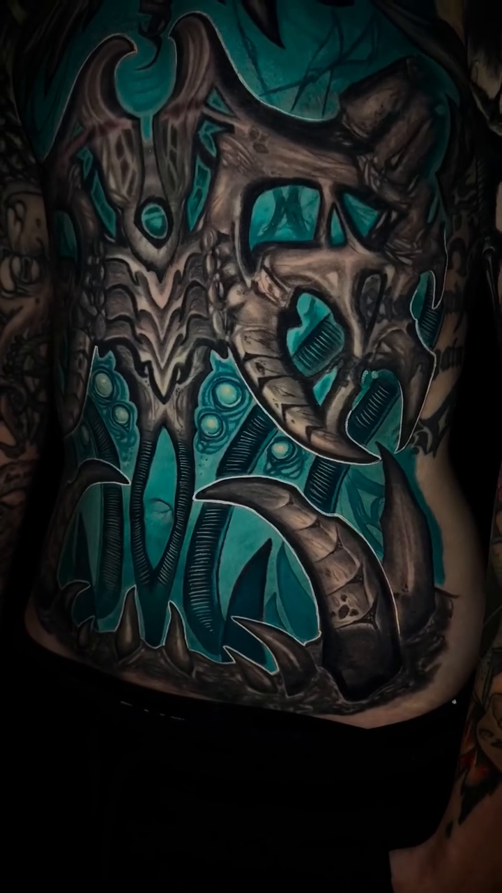 Biomechanical dragon blackwork tattoo by Caitlyn Campbell