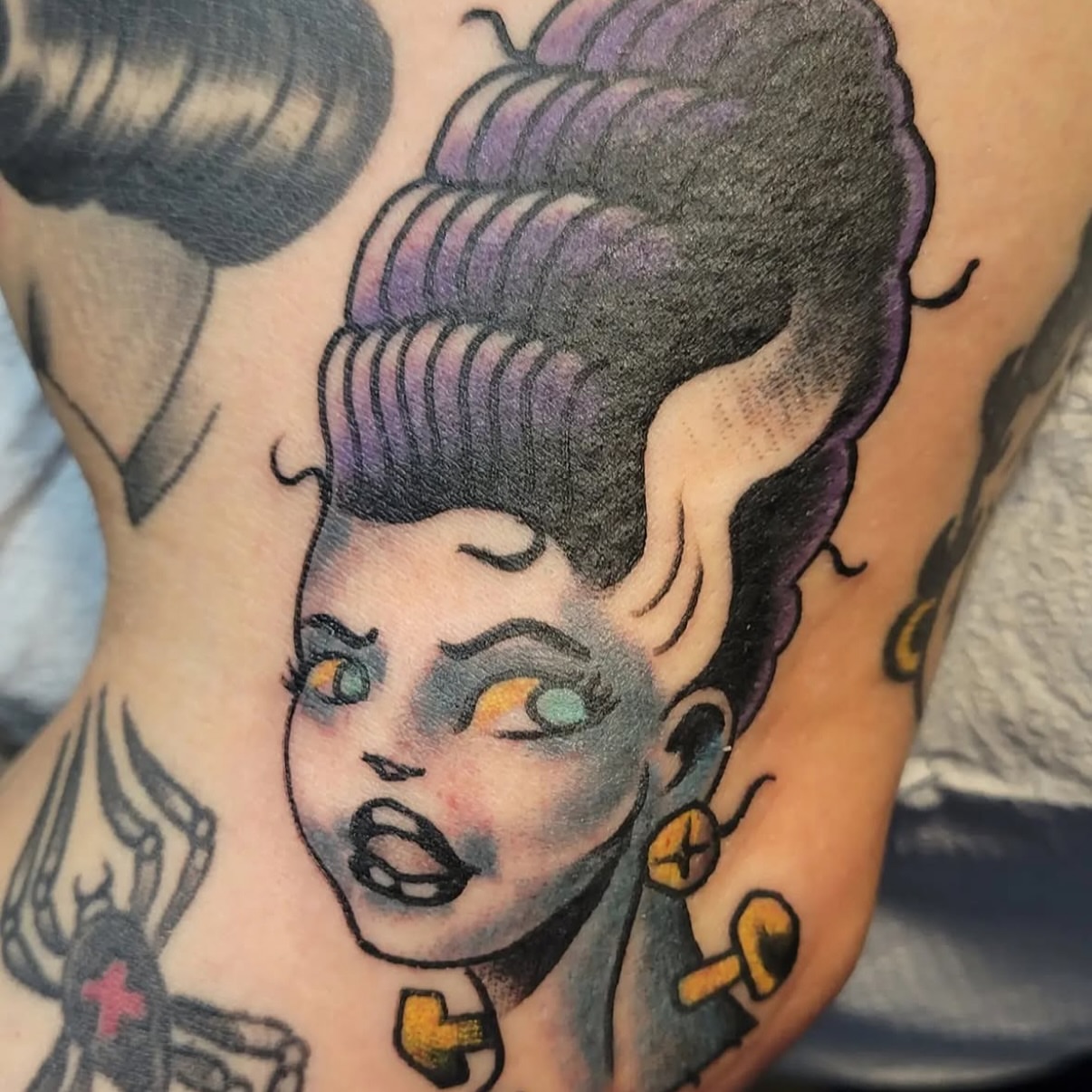 Woman with exaggerated hairstyle American traditional tattoo on the back by Mark Harada, Hoboken, New Jersey