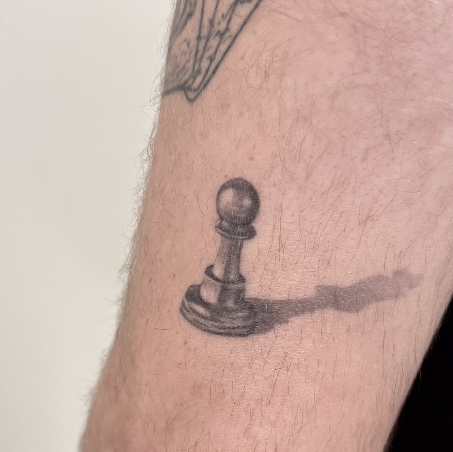 Chess pawn black and grey tattoo on the forearm by Marisa Martello, Nashville, Tennessee