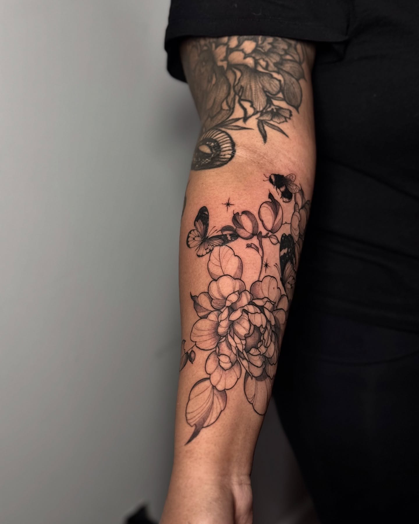 Flowers and butterflies black and grey tattoo on the forearm by Kbtattz