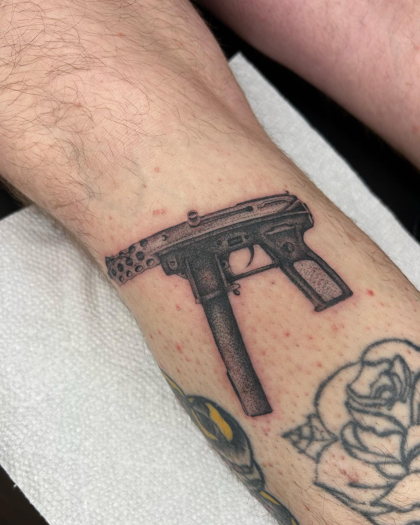 Machine gun dotwork tattoo on the forearm by Alex Lang