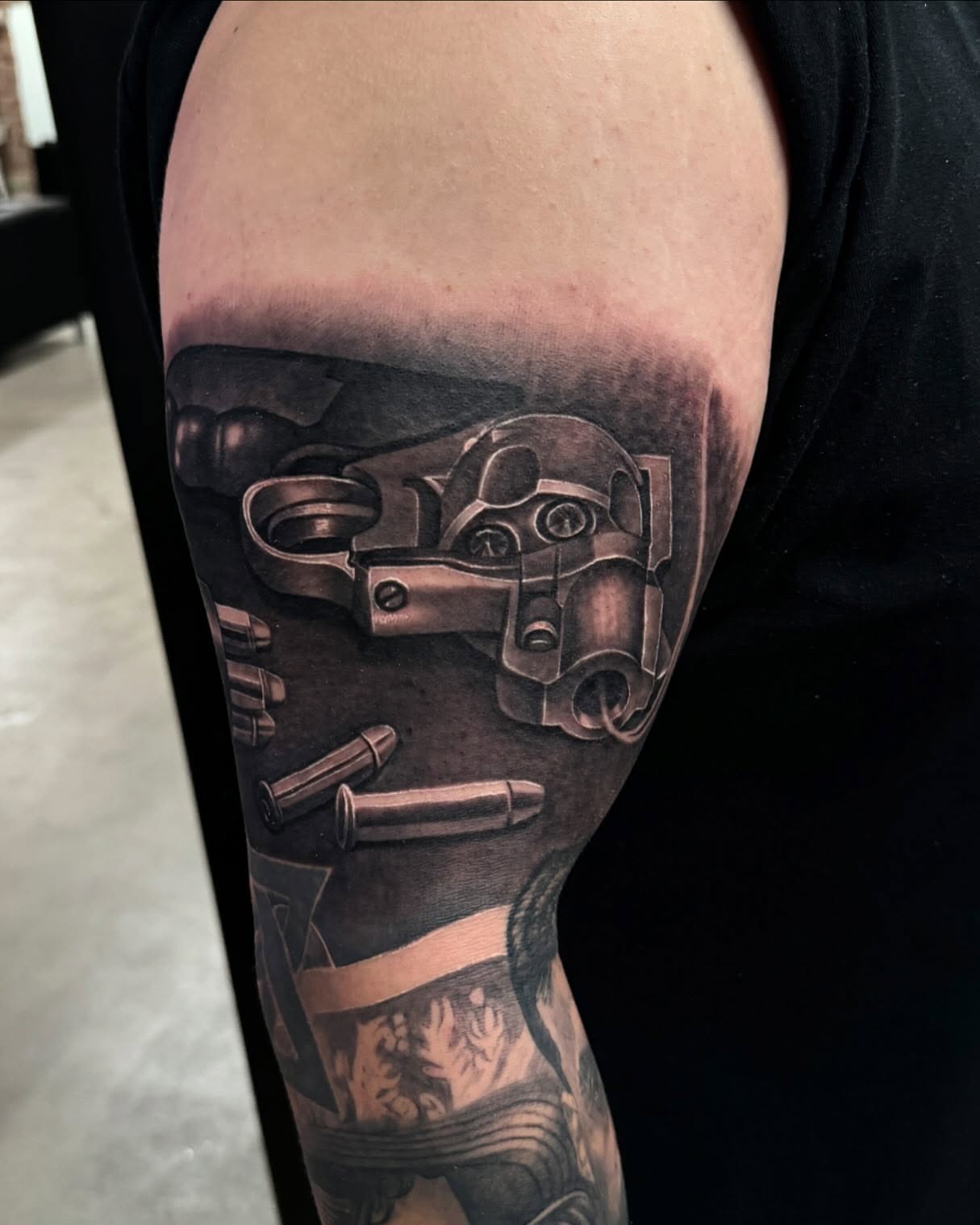 Gun and bullets realism tattoo on the forearm by Anthony Duran