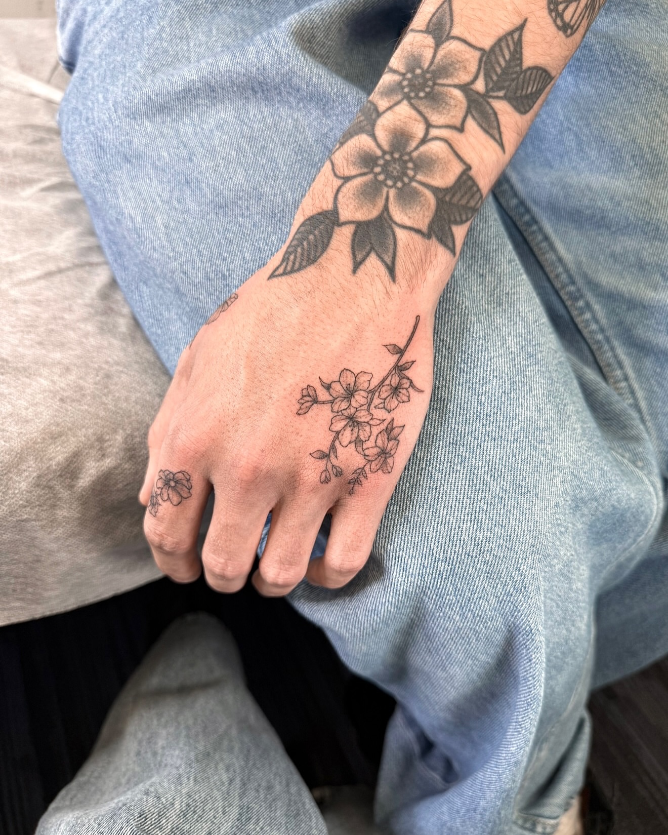 Flower and branch black and grey tattoo on the forearm by Your tattoo Artist, New York, New York