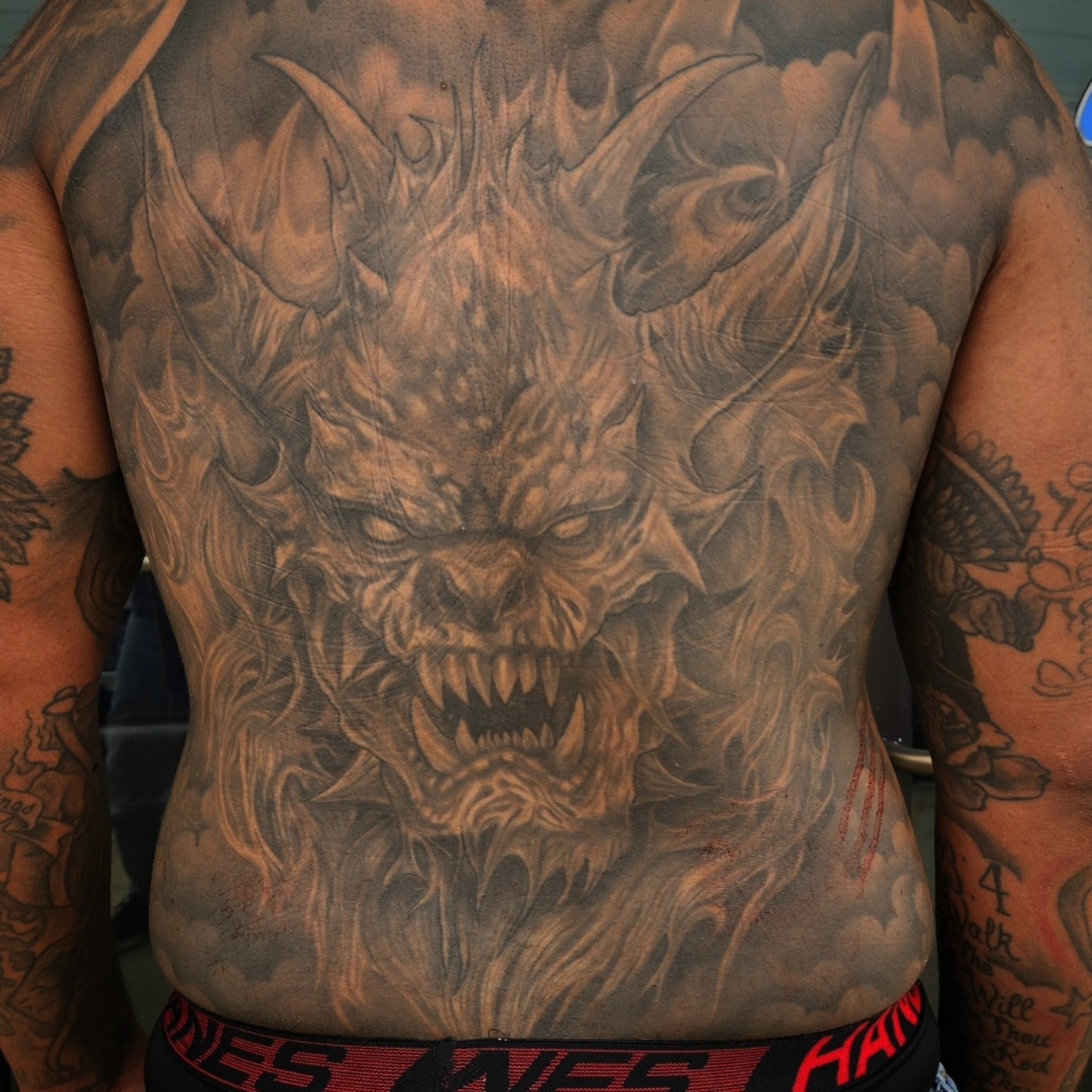 Demon dark realism tattoo on the back by Mike Bugenhagen