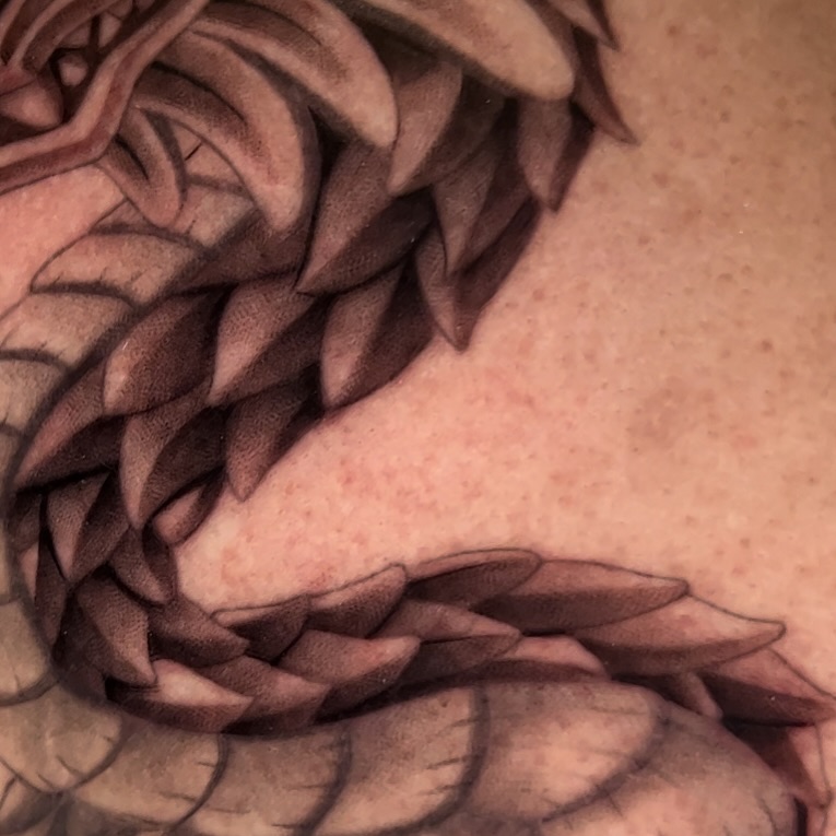 Scale pattern black and grey tattoo on the shoulder by Geo