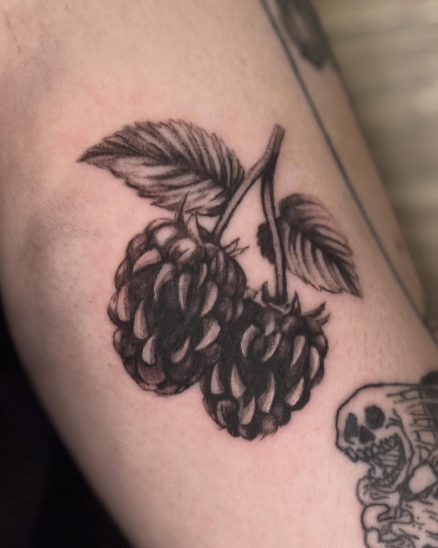 Mulberries black and grey tattoo on the upper arm by jordy