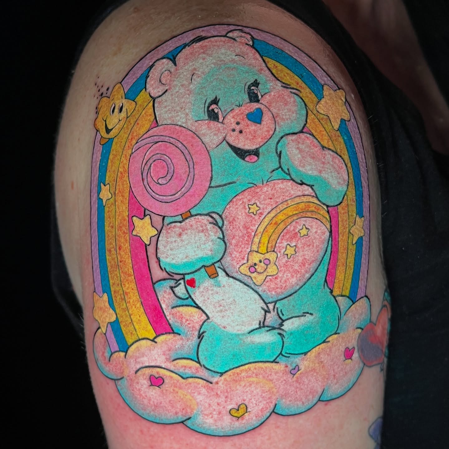 Care bear new school tattoo on the upper arm by Jess Watts