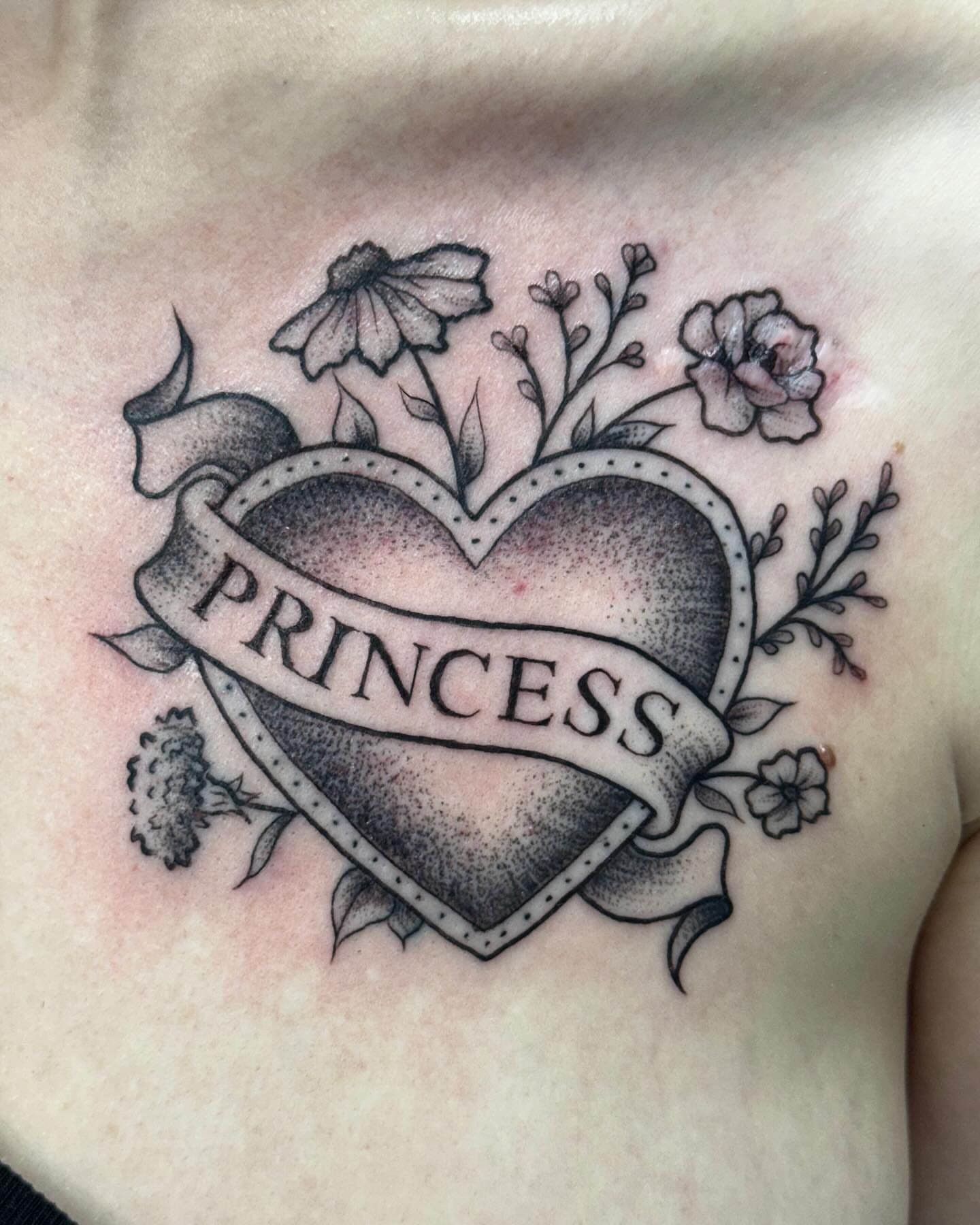 Heart with 'princess' banner dotwork tattoo on the chest by Lacee-Beth Finch